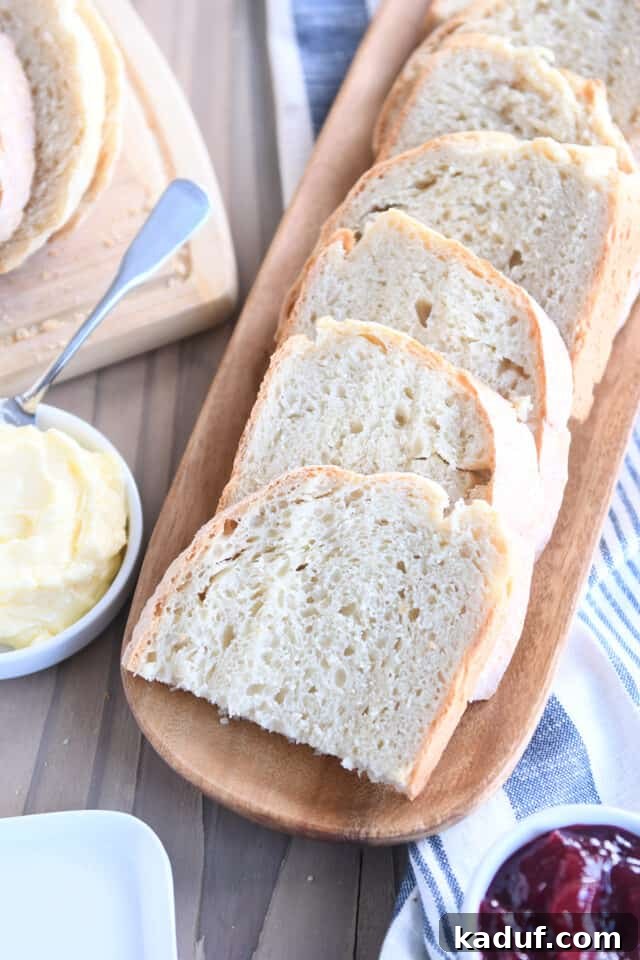 Effortless Rustic Sourdough Loaf 2 Six half slices of soft, fluffy sourdough peasant bread on a rustic wooden tray, ready to be enjoyed.