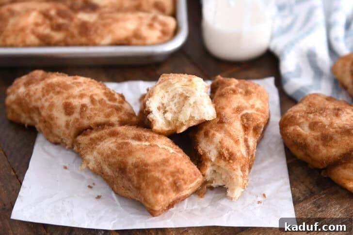 Fluffy Cinnamon Sugar Knots 9 Three cinnamon sugar twists on white parchment paper with one broken in half. These buttery cinnamon sugar twists are unbelievably delicious. Easier than cinnamon rolls, they are soft, fluffy and delicious plain or with a bit of sweet icing!