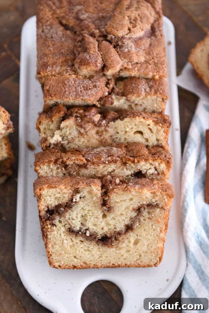 Cinnamon Bliss Loaf 2 Slices of delicious cinnamon swirl quick bread on a white tray.