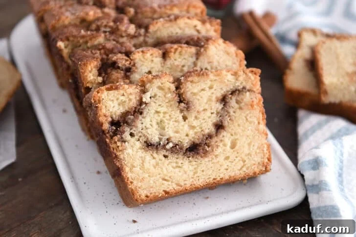 Cinnamon Bliss Loaf 10 Three slices of cinnamon swirl quick bread on a white tray.