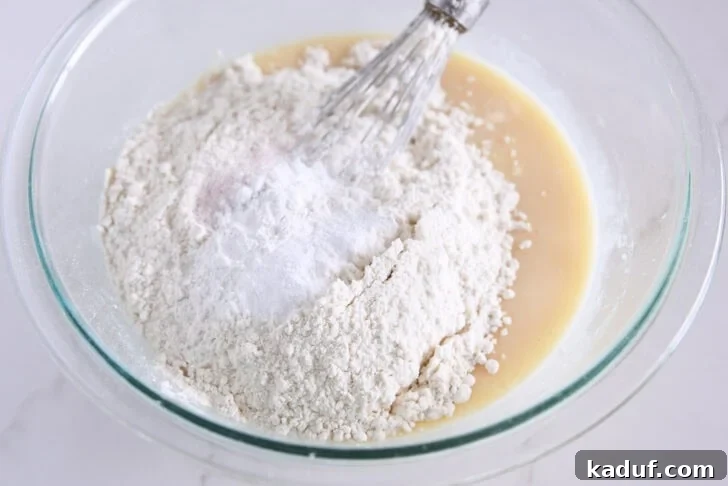 Cinnamon Bliss Loaf 5 Adding dry ingredients to the quick bread batter.