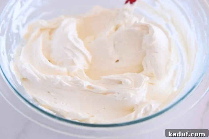 Grandma's Secret Sheet Cake Recipe 7 Whipped cream cheese frosting in a glass bowl.