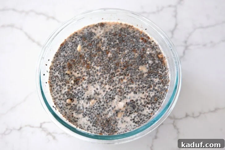 Best Ever Overnight Chia Oats 11 Glass bowl with basil seeds, oats, and almond milk