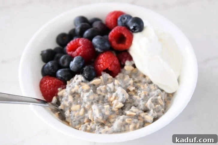 Best Ever Overnight Chia Oats 13 White bowl with chia oats, blueberries, Greek yogurt, and raspberries
