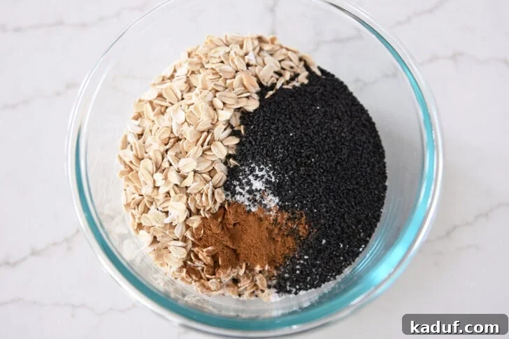 Best Ever Overnight Chia Oats 9 Glass bowl with basil seeds, oats, cinnamon, and salt