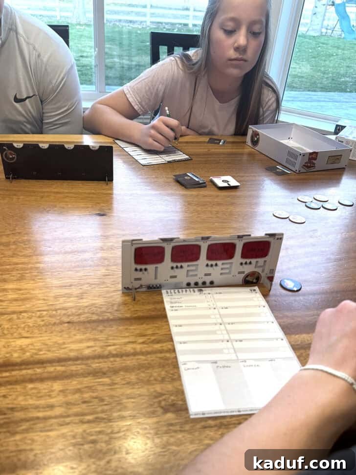 Friday Musings 10 A family playing the Decrypto game. Family fun night.