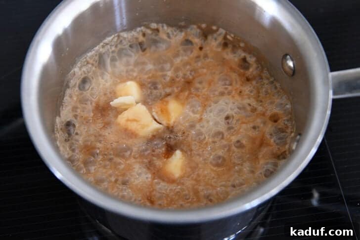 Saucepan with sugar and water mixture, butter, and cream.