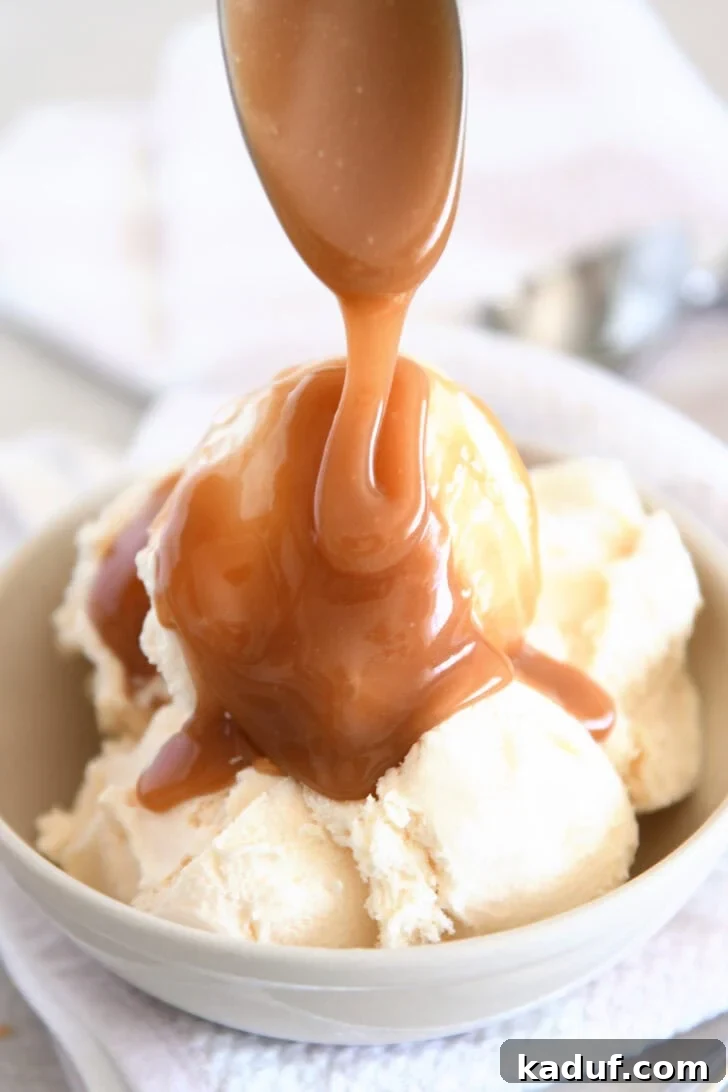Drizzling caramel sauce over vanilla ice cream.