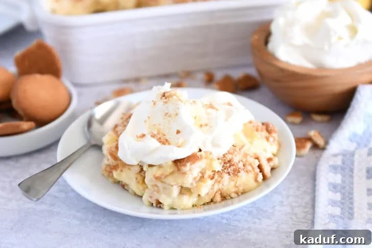 Homemade Banana Pudding from Scratch: Creamy Classic Recipe 14 Serving of banana pudding on white plate topped with whipped cream.