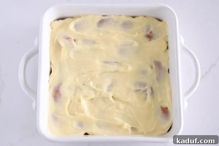 Homemade Banana Pudding from Scratch: Creamy Classic Recipe 10 White square 8X8 baking dish with vanilla pudding layered over nilla wafers.