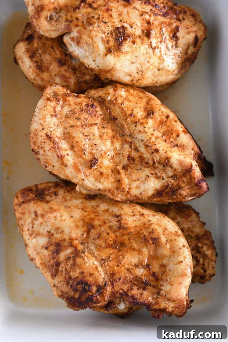 Weeknight Chicken Fajitas with Peppers and Onions 4 Cooked chicken breasts covered in fajita seasoning.
