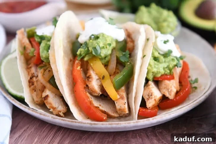 Weeknight Chicken Fajitas with Peppers and Onions 6 Three flour tortillas filled with sliced, cooked chicken, bell peppers, onions, guacamole and sour cream.